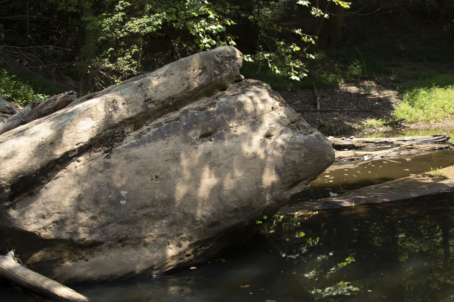 Crescent pinhole spotlights on a boulder